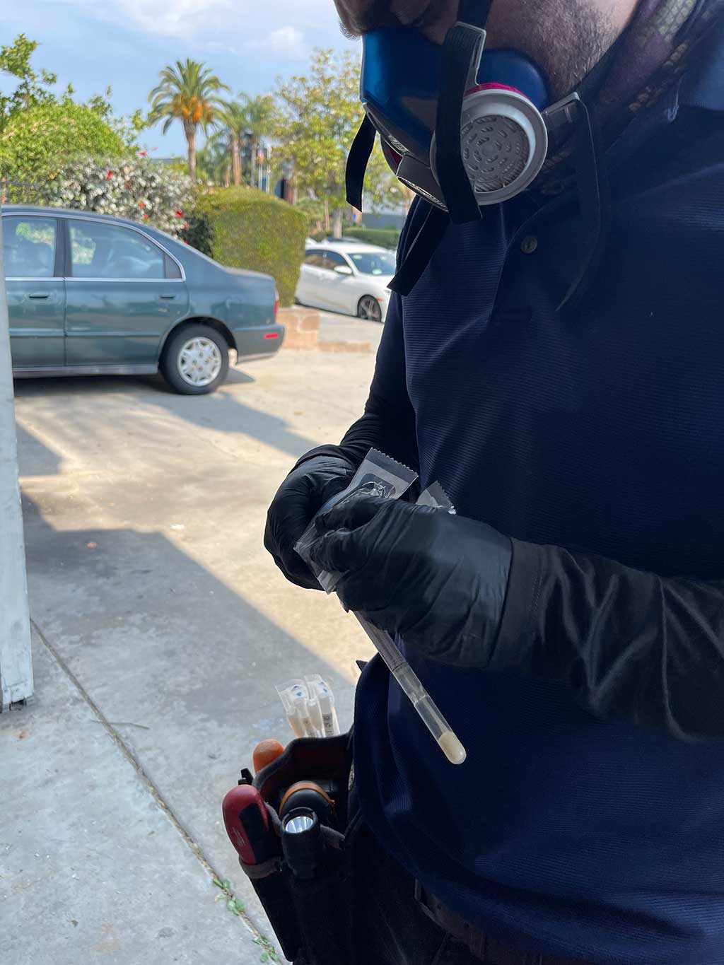 Environmental Services Employee Wearing Safety Respirator