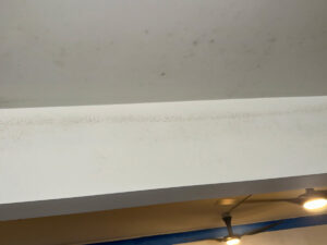 White Ceiling Showing Patches Of Mold, Indicating Potential Moisture Issues In The Room.