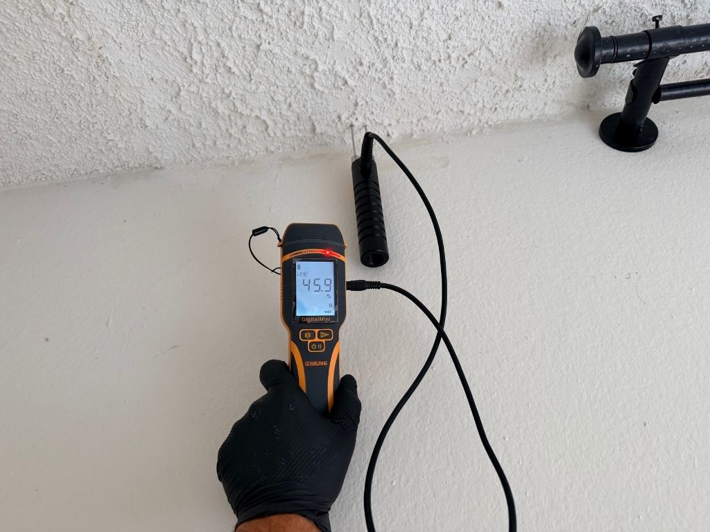 User-Inserted Image Showing A Mold Detection Device With A Reading Of 45.9, Used During A Real Estate Mold Inspection To Assess Moisture Levels In A Property.