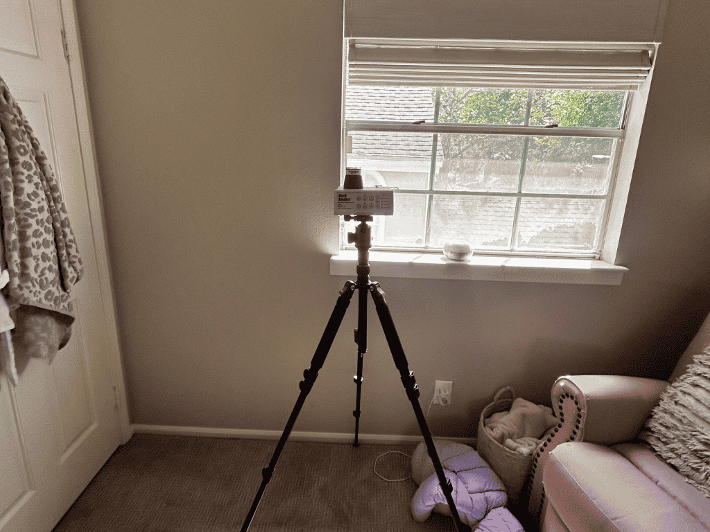 Air Quality Testing Equipment Set Up Inside A Home Near A Window