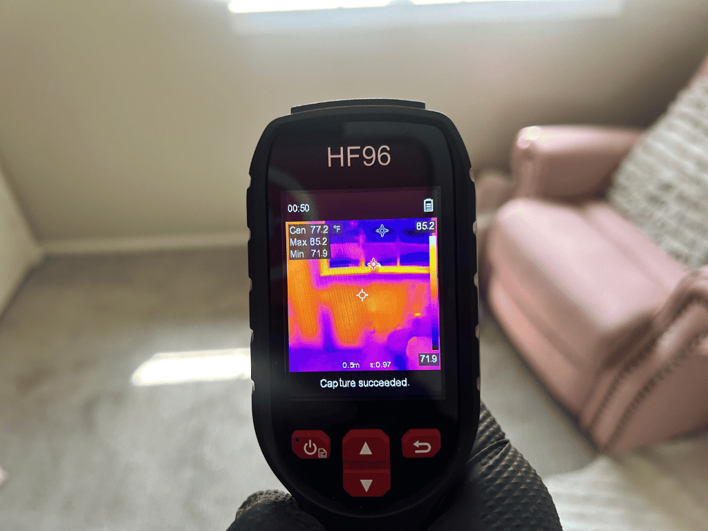 Thermal Imaging Camera Detecting Moisture Conditions During An Indoor Mold Inspection